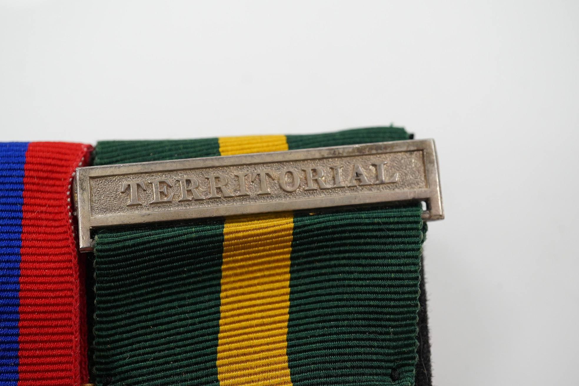 A group of 4 medals including MBE in display case